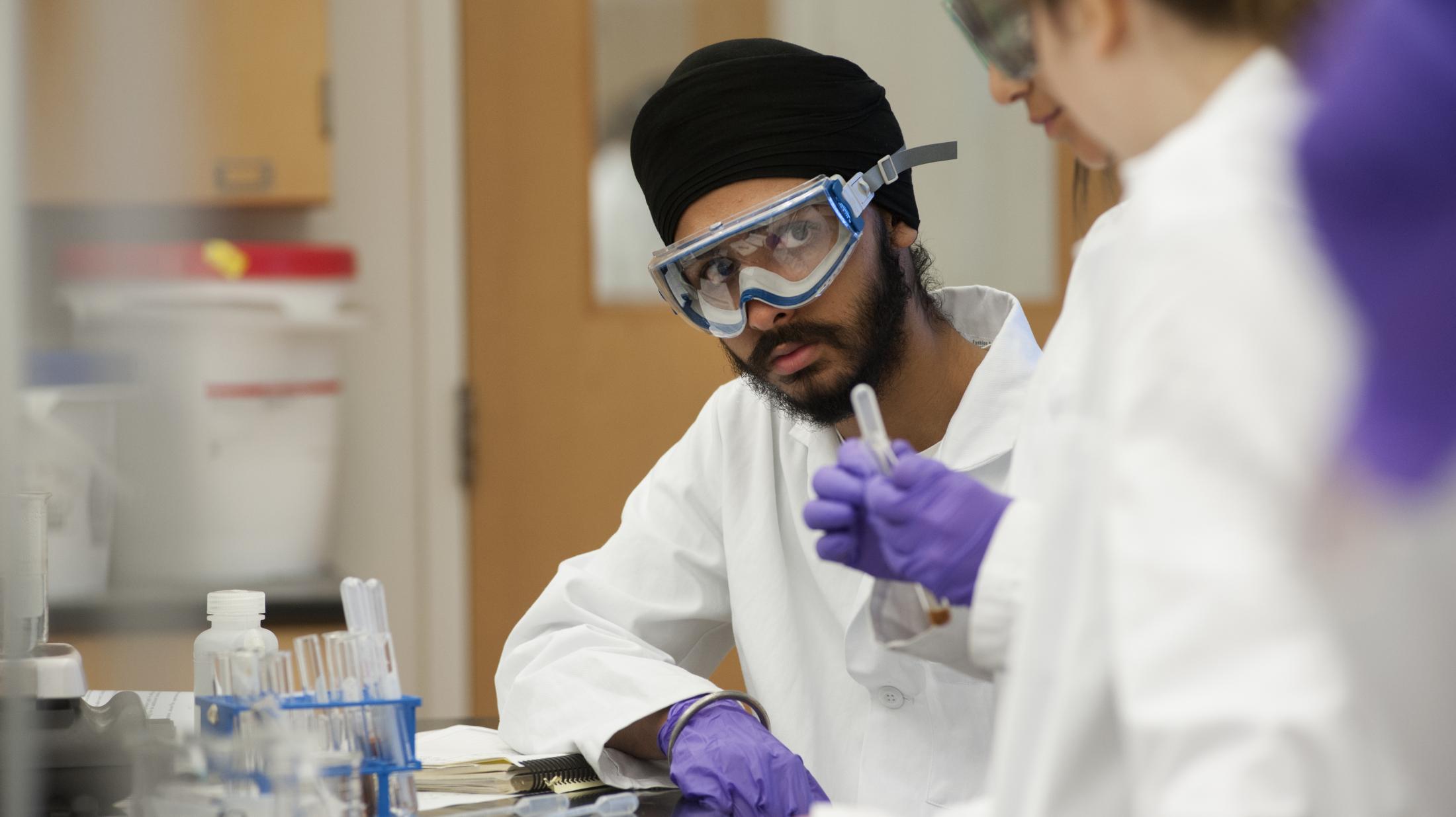 Harpreet Singh talks with other UC Davis students during a Chemistry 2C lab at UC Davis on Tuesday, April 29, 2014.  The students were preforming qualitative analysis on a solution, trying to identify the five cations present.