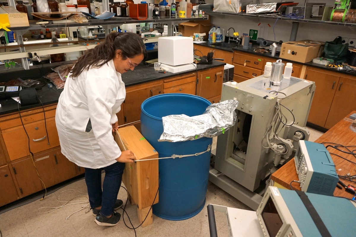 Michele applying an inhomogeneous magnetic field to a tomato paste bin.