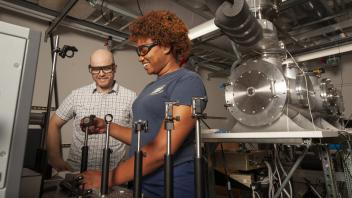 Ke'La Kimble, a chemistry major, works with associate professor Kyle Crabtree as he show her how laser mirrors are calibrated.