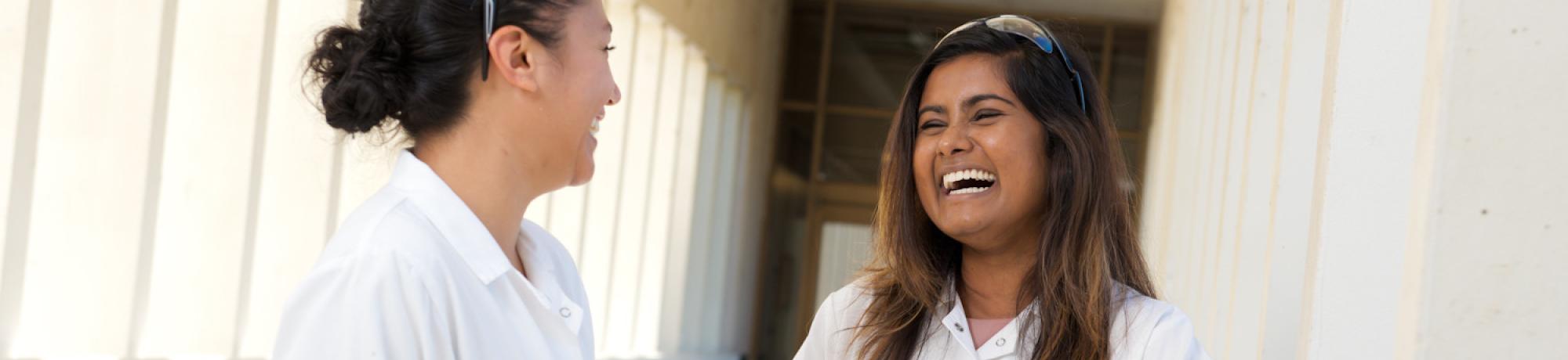 Two graduate students talking in the Chemistry Building breezeway