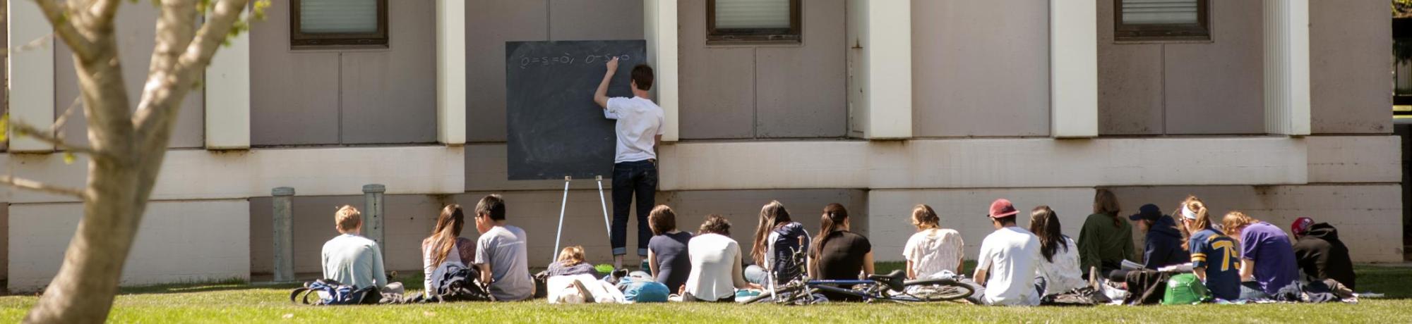 Teaching Assistant Tim Shelton, a graduate student in chemistry, goes over students' questions outside the Chemistry Annex on Tuesday, March 18, 2014.