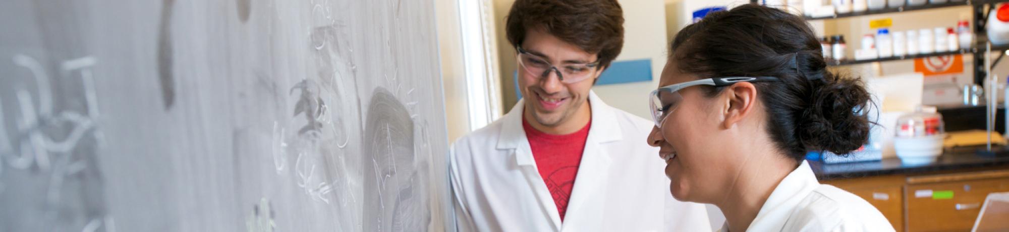 Two graduate students in a lab.