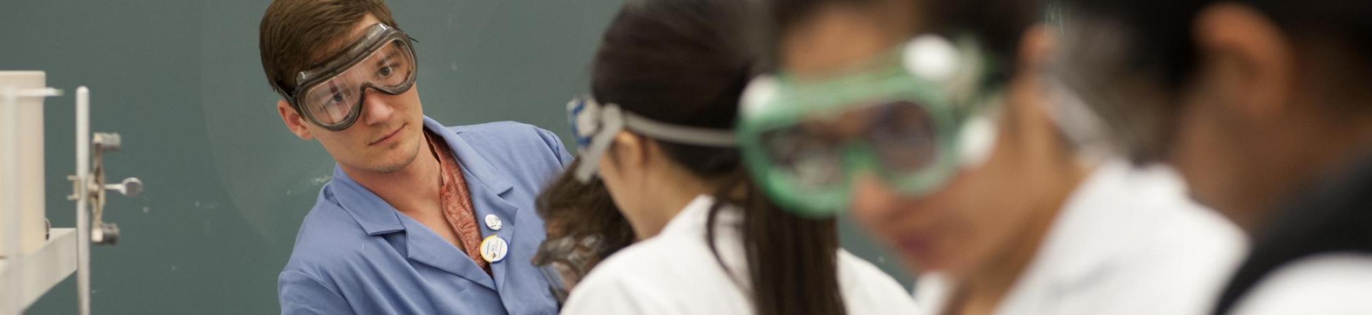 UC Davis teaching assistant Tim Shelton talks with UC Davis students during a Chemistry 2B lab at UC Davis on Monday, May 5, 2014. The students were looking for chemical equilibrium using observational color shifts.
